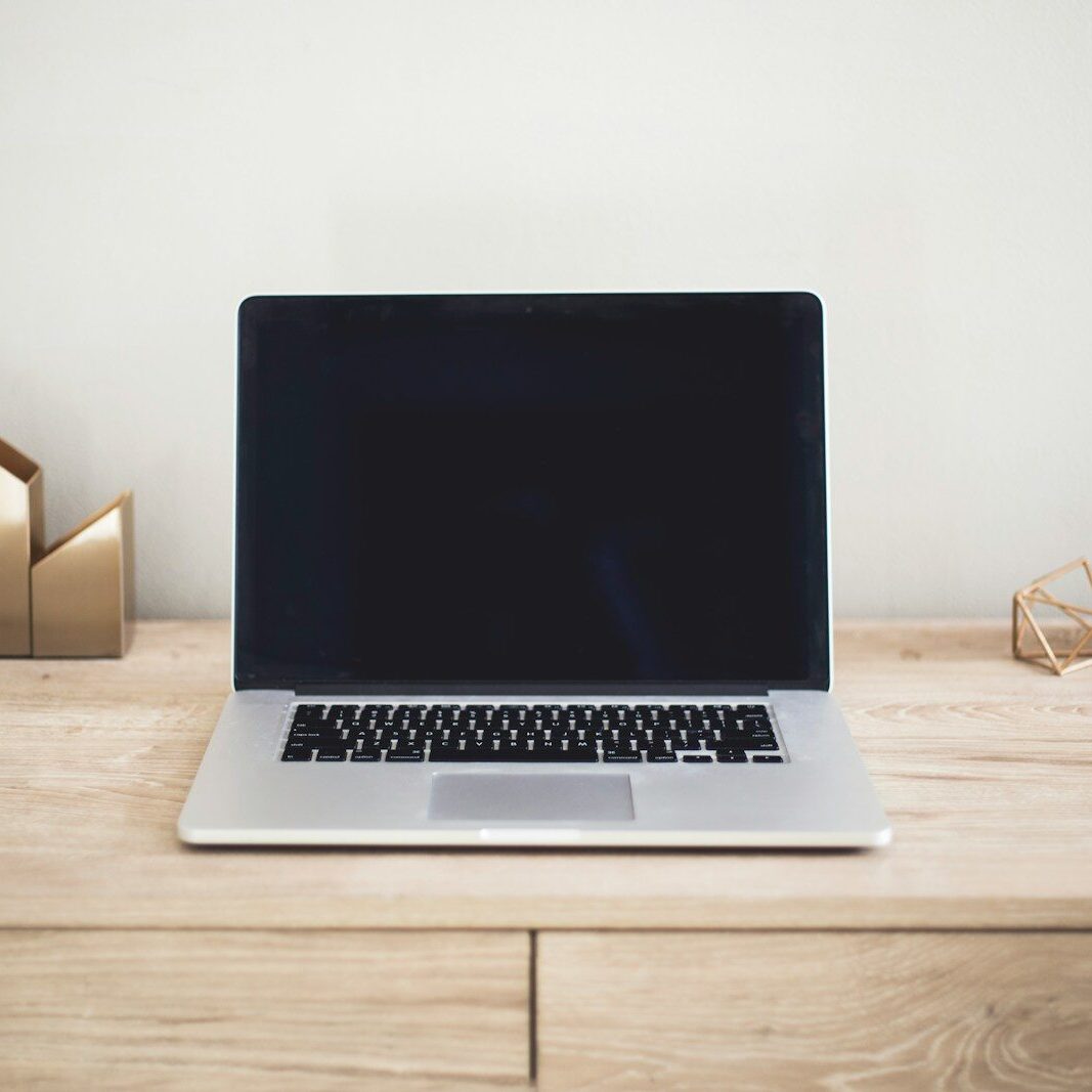 MacBook Pro on top of brown table