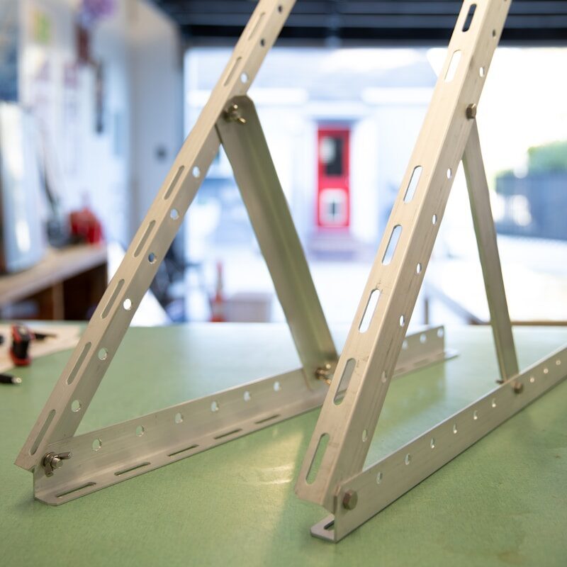 a pair of metal brackets sitting on top of a table
